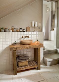 a bathroom with a wooden sink and tiled walls