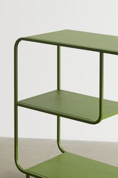 a green side table with two shelves on each side and one shelf below the top