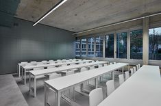 an empty room with tables and chairs in it