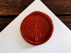 a red wax stamp sitting on top of an envelope