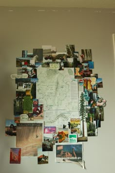 a bulletin board covered in pictures and magnets on the wall above it is a map