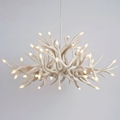 the light fixture is made out of antler branches and has white lights on it