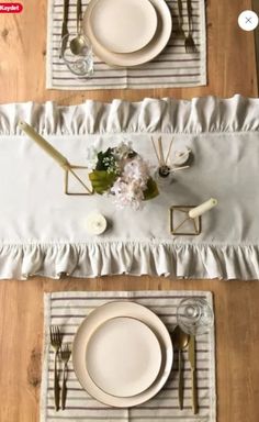 the table is set with white plates and silverware, along with napkins and place mats