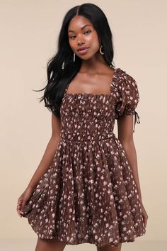 You'll be the first thing on your sweetie's mind in the Lulus Delightful Crush Brown Floral Smocked Puff Sleeve Mini Dress! Lightweight woven fabric, with a burnout design and ditsy floral print throughout, shapes short puff sleeves with elastic cuffs and bow details. Ruffle-trimmed square neckline tops a smocked bodice with a fitted waist. Flaring skirt finishes at a bubble-style mini hem. Fit: This garment fits true to size. Length: Mid-thigh. Size medium measures 26.5" from shoulder to hem. B Cute Fitted Smocked Mini Dress, Cute Dresses With Smocked Bodice For Brunch, Brown Ruched Smocked Dress For Summer, Brown Smocked Dress For Summer, Cute Smocked Puff Sleeve Fitted Dress, Cute Fitted Smocked Dress With Puff Sleeves, Cute Fitted Smocked Dress With Ruffle Hem, Cute Mini Smocked Dress With Smocked Bodice, Spring Fitted Brown Smocked Dress