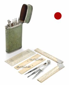 a green case with scissors, rulers and other tools in it on a white background