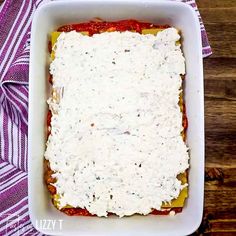 a square casserole dish filled with cheese and sauce