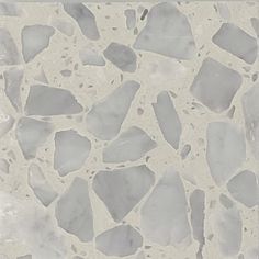 a white and gray tile with small rocks on it