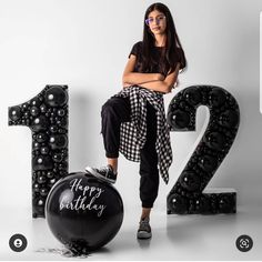 a woman sitting on top of a black balloon in front of the number twenty two