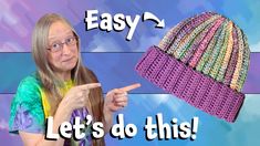 a woman pointing at a crocheted hat with the words easy and let's do this