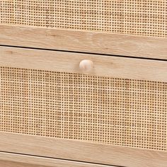 a close up of a wooden drawer with wicker on it