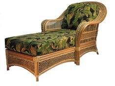 a wicker chaise lounge chair with tropical print upholster