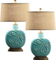 two blue ceramic table lamps with beige linen shades