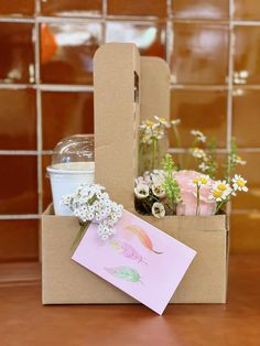 an open cardboard box with flowers in it