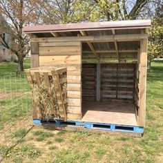 a small shed with hay in the back