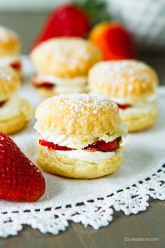 small pastries with strawberries on a doily