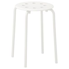 a white stool with four holes on the top and bottom, sitting in front of a white background