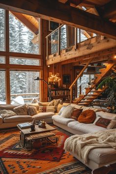 a living room filled with lots of furniture next to a staircase leading up to a second story