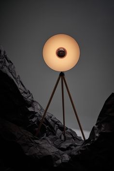 a light that is sitting on top of a tripod in the middle of some rocks