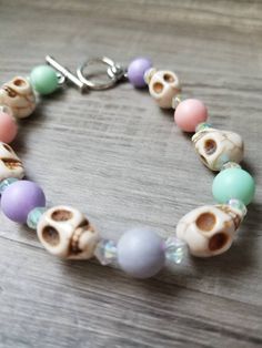 This pastel bracelet has alternating pink, purple and green beads with cream white skulls. It has a toggle clasp LOCAL? If you are local to the Houston (North) area and would like to pick up your item, please leave a comment in the note to seller portion. Pick-up can then be arranged when the item is completed and shipping charges will be reimbursed. GHOST CANDY CREATIONS BE UNAPOLOGETICALLY, YOU! Simple Beaded Bracelets, Pastel Bracelet, Goth Accessories, Toggle Bracelet, Pastel Goth, Cream White, Green Bead, Pretty Jewellery, Houston