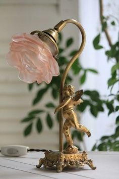 a lamp with a pink flower on top of it