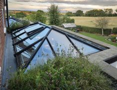 the roof of a house with many windows and plants growing on it's sides