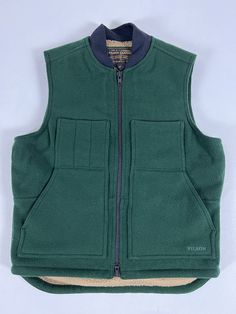 FEATURES Built with tightly-woven Mackinaw Wool Zipper-front closure Lined with high-pile Sherpa fleece Wool-blend rib-knit collar Dropped tail for added coverage Slotted and utility chest pockets; interior-chest pocket MANUFACTURING SKU: 20199228 Made in Bangladesh Material: 24-oz. 100% virgin wool + 11-oz. 74% polyester/14% acrylic/12% wool Sherpa fleece + 6-oz. dry finish Cover Cloth Brand new with tag. 1st quality! Made in Bangladesh. Measurements: Pit to pit: 26” Back center length (exclude Craftsman Clothing, Drippy Fits, Work Vest, Cloth Brand, Wool Work, Player 1, Plaid Vest, Wool Plaid, Sherpa Fleece