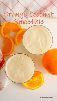 orange coconut smoothie in small glasses next to sliced oranges