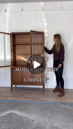 a woman standing in front of a cabinet with the words can you modernize this cabinet?