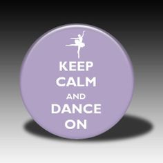 a purple button with the words keep calm and dance on in white letters, against a black background