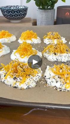 an image of food that is being prepared on a baking sheet with cheese and black sesame sprinkles