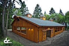 a large wooden building sitting in the middle of a forest