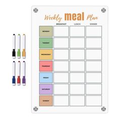 a weekly meal planner with markers and pens