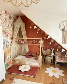 a child's bedroom decorated in pink and white with flowers on the bedding