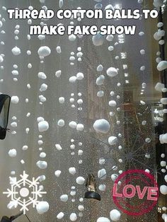 the window is covered with white balls and snowflakes