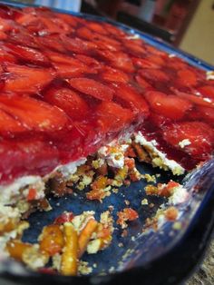 there is a cake with strawberries on it and other toppings in the pie dish