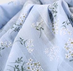 the fabric is blue with white flowers on it