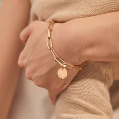 Forever linked by love. Featuring an iconic hinge to clip on your hand-engraved charms, this personalized link bracelet can be hand-engraved with your special words or messages.Available in 18K Champagne Gold PlatedCharm: 0.6 Diameter, 0.03 ThicknessChain length &amp; style: 7.3 Thick Trace ChainCharms are removable from this chain and can be worn with other Merci Maman charmsHand-engraved in our Paris workshopSent with love in a complimentary gift boxAny slight variations in lettering depth Elegant Personalized Gold Plated Chain Bracelet, Elegant Personalized Chain Bracelet, Personalized Metal Chain Bracelet, Elegant Personalized Gold Charm Bracelet, Luxury Adjustable Bracelet With Logo Charm, Personalized Gold Metal Chain Bracelet, Personalized Jewelry For Mom, Bracelet Or, Jewelry Packaging Design