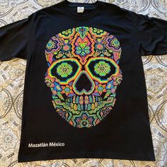 Never Worn Large Black T-Shirt With Very Bright Puffy-Painted Skull. Purchased In Mazatln Mexico. Very Striking. Chest 21” & Length 29” Neon Graphic Print T-shirt With Crew Neck, Casual Neon T-shirt With Screen Print, Neon Cotton Crew Neck T-shirt, Black Cotton Rave T-shirt, Black Rave T-shirt With Screen Print, Fun Black Printed Top, Rave Multicolor Cotton Top, Multicolor Skull Print Crew Neck Top, Pink Graphic Print T-shirt For Festivals