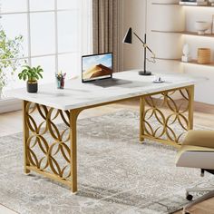 a computer desk with a laptop on top of it in front of a large window