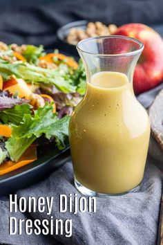 a plate with salad and dressing next to a bottle of honey dijon dressing on it