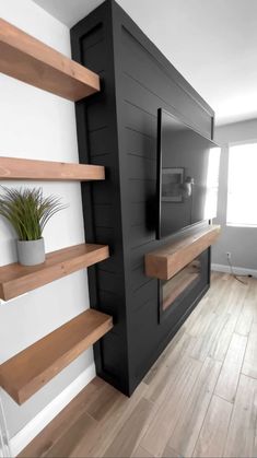 there is a tv on the wall in this living room with shelving and shelves