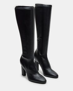 Elevate your style with our ARIA knee-high heeled boot . Crafted with a sleek design, these boots will add a touch of sophistication to any outfit. You can confidently step out in style with a comfortable heel height and secure fit. Perfect for any fashion-forward individual.  4 inch heel height Size 6 measurements: 13.5 inch shaft circumference, 14.5 inch shaft height  Size 8 measurements: 14 inch shaft circumference, 15.75 inch shaft height Size 10 measurements: 15 inch shaft circumference, 16.5 inch shaft height Vegan leather upper material Textile lining Vegan leather sock Synthetic sole Imported Steve Madden Store, Vegan Leather Handbag, Black Knee High Boots, Leather Socks, Black Knees, Comfortable Heels, 4 Inch Heels, 5 Inch Heels, Designer Heels