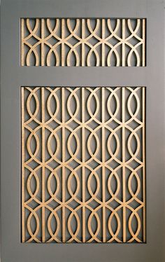 an art deco paneled in wood with circles and lines on the sides, as well as two smaller panels