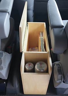 the back seats of a car with various items in their bins and storage boxes