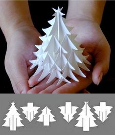 the paper christmas tree is being held by two hands