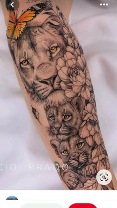 a woman's arm with a lion and flowers on it