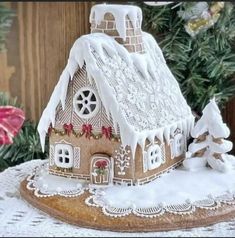 a gingerbread house on a doily covered table