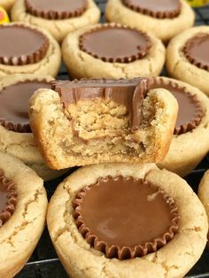 peanut butter cupcakes with chocolate in the middle on a cooling rack, ready to be eaten