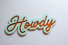 the word hodgy is made out of wood and has orange lettering on it