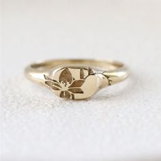 Solid Gold Signet Ring With Floral Lily Engraving. Ideal As Fashion Ring But Can Also Be Stacked As A Wedding Band. This Listing Is For The Single Ring. 14k Gold Width: Widest Part 6mm And .25 Inch Wedding 14k Gold Signet Ring With Round Cut, Dainty Recycled Gold Signet Ring For Wedding, Classic Round Flower Ring In 14k Gold, Classic 14k Gold Round Flower Ring, Delicate 14k Gold Engraved Ring, Delicate Engraved 14k Gold Ring, Delicate Yellow Gold Engraved Ring For Anniversary, Classic Yellow Gold Flower Ring As Gift, Classic Yellow Gold Flower Ring For Gift